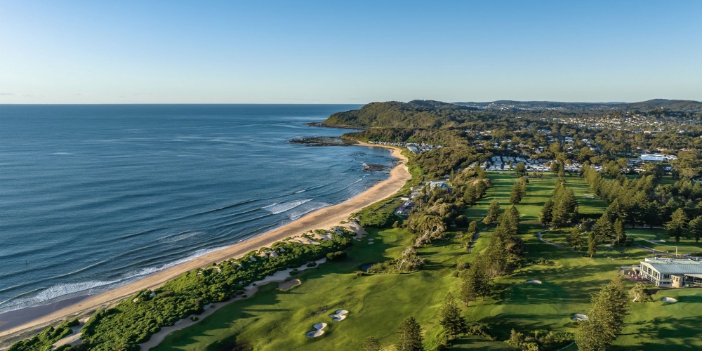 Aerial view of Shelly Beach Golf Club overlooking the coastline near The Entrance, with manicured fairways, beachside greens, ocean views, and surrounding coastal landscape.