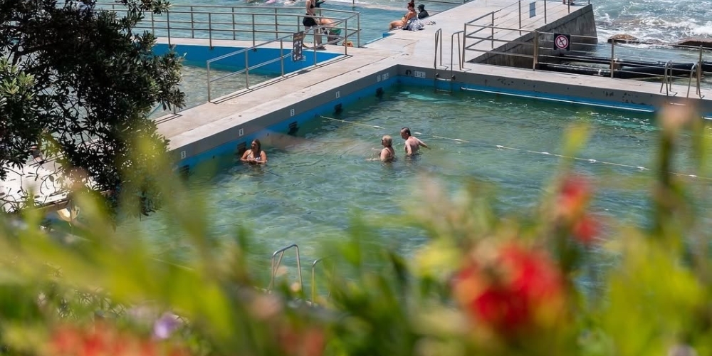 Visitors enjoying Grant McBride Baths at The Entrance, featuring ocean-fed swimming pools with panoramic coastal views and accessible pool access.