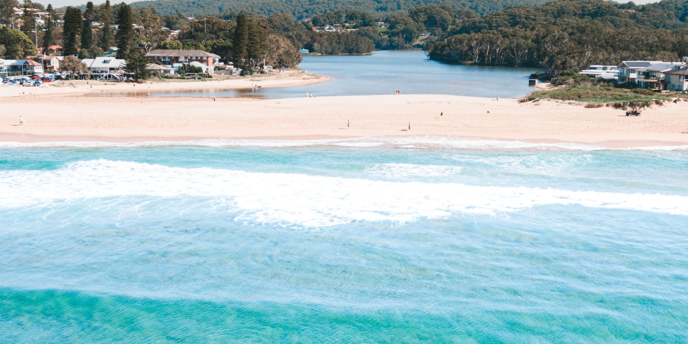 Aerial view of Avoca Beach and Avoca Lake on the NSW Central Coast, with the ocean, sandy beach and lagoon.